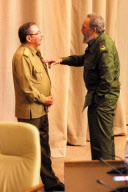 Fidel Castro talks to his brother Raul Castro