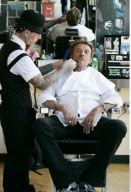 Singer JOHNNY HALLYDAY driving in his vintage roadster to a barber shop