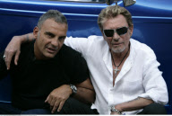 Singer JOHNNY HALLYDAY driving in his vintage roadster to a barber shop