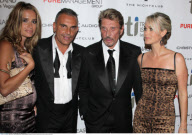 Designer CHRISTIAN AUDIGIER and pregnant girlfriend IRA arriving at 'Treasure Island' hotel