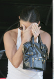 Actress DEMI MOORE hiding from the cameras while leaving a nail salon