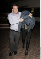 EXCL.: Billionaire twin ASHLEY OLSEN hiding under a friends jacket when leaving an office