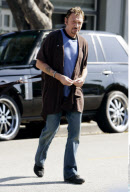 Singer JOHNNY HALLYDAY running around with a unfinished hair cut