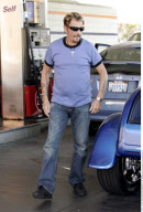 Singer JOHNNY HALLYDAY running around with a unfinished hair cut