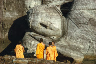 MONKS IN FRONT OF LYING BUDDHA STATUE, POLONNARUWA, SRI LANKA
