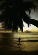 WOMAN AT SUNSET, BEAU VALLON BEACH,  MAHé ISLAND, SEYCHELLES