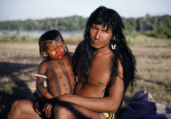 INDIAN FATHER HOLDING HIS DAUGHTER BEFORE THE FESTIVAL, XINGU INDIAN RESERVATION, BRAZIL