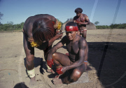 MEN WITH HAIR DECORATION AT THE VILLAGE SQUARE, PREPARED FOR FESTIVAL, XINGU INDIAN RESERVATION, BRAZIL