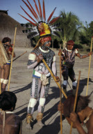 INDIAN CHIEF WITH FEATHER HEADDRESS; FESTIVAL DECORATION AND BODYPAINTING, XINGU INDIAN RESERVATION, BRAZIL