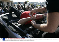 Dean Gunnarson attempts to escape after being chained to the roof of a vehicle as it goes through a car wash, Winnipeg, Manitoba, Canada - 31 Oct 2008