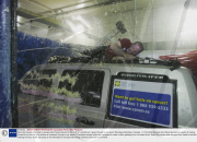 Dean Gunnarson attempts to escape after being chained to the roof of a vehicle as it goes through a car wash, Winnipeg, Manitoba, Canada - 31 Oct 2008