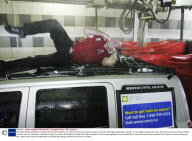 Dean Gunnarson attempts to escape after being chained to the roof of a vehicle as it goes through a car wash, Winnipeg, Manitoba, Canada - 31 Oct 2008