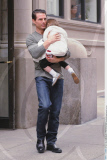 Muscular actor TOM CRUISE keeps little SURI smiling