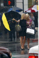 Actresses JENNIE GARTH and TORI SPELLING get caught in the rain
