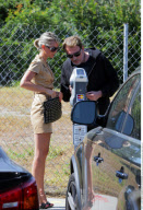Musician JOHNNY HALLYDAY and wife LAETICIA feeding the parking meter together in Beverly Hills
