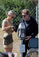Musician JOHNNY HALLYDAY and wife LAETICIA feeding the parking meter together in Beverly Hills