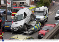 Nissan Terrano Ends Up on Top of Police Car During a Chase in Swansea, Wales, Britain - 14 Apr 2009