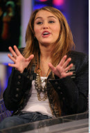 Actress MILEY CYRUS making funny faces and feeding a donky at the tv show 'The Ants' in Madrid