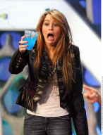 Actress MILEY CYRUS making funny faces and feeding a donky at the tv show 'The Ants' in Madrid