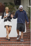 Heiress PARIS HILTON needs a helping hand from boy-toy DOUG REINHARDT while walking in her black killer high heels