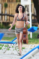 Amy Winehouse with guitar on the beach