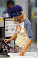 Heiress PARIS HILTON has to take off her $890 Louboutins at the LAX airport
