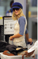 Heiress PARIS HILTON has to take off her $890 Louboutins at the LAX airport