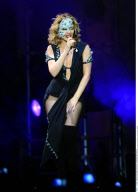 Sexy KYLIE MINOGUE dons a glittering mask and a hot bodysuit as she performed in Madrid