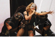 Sexy KYLIE MINOGUE dons a glittering mask and a hot bodysuit as she performed in Madrid