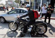 Cool JUSTIN TIMBERLAKE was surrounded by paparazzi as he jumped on his Harley
