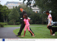 US President Barack Obama is welcomed by daughters Sasha and Malia on the South Lawn of the White House, Washington DC, America - 15 Sep 2009
