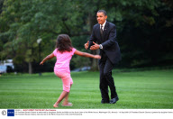 US President Barack Obama is welcomed by daughters Sasha and Malia on the South Lawn of the White House, Washington DC, America - 15 Sep 2009