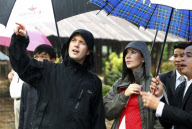 PRINCE FREDERIK and PRINCESS MARY standing in the rain at the Minh Mang Temple