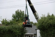 Gardener uses ride-on lawnmower to trim hedge, Cambridge, New Zealand - Nov 2009