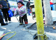 Father chains 2-year-old son by roadside while working to stop him being 'stolen', Liangxiang, Beijing, China - Feb 2010