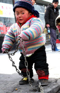 Father chains 2-year-old son by roadside while working to stop him being 'stolen', Liangxiang, Beijing, China - Feb 2010