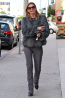 Bright smiling ELLEN POMPEO dons a furry jacket while leaving a business meeting