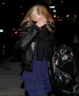 Kate Bosworth hides from the flashes at the Bowery Hotel