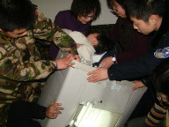 Police, firefighters and repairman free child trapped in washing machine, Xi'an, Shaanxi province, China - 11 Mar 2010