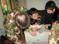 Police, firefighters and repairman free child trapped in washing machine, Xi'an, Shaanxi province, China - 11 Mar 2010