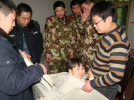 Police, firefighters and repairman free child trapped in washing machine, Xi'an, Shaanxi province, China - 11 Mar 2010