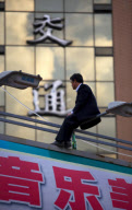 Man threatening suicide dragged to safety by police officers, Kunming, Yunnan province, China - 10 May 2010