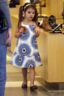 Actress KATIE HOLMES shows off her maltreated feet while shopping with SURI at Barneys New York