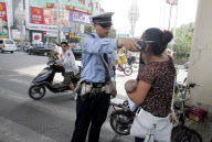 Suspect thief stamps on baby after stopped by police, Zhengzhou, Henan province, China - 24 May 2010