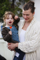 Model MILLA JOVOVICH with worst swollen eyes running errands with little EVER