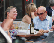 SIR STIRLING MOSS ENJOYING A BEER IN THE SUN