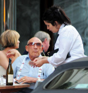 SIR STIRLING MOSS ENJOYING A BEER IN THE SUN