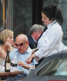 SIR STIRLING MOSS ENJOYING A BEER IN THE SUN