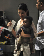 Sandra Bullock Departs Austin Airport with Louis Bardo