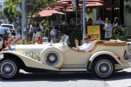ARNOLD SCHWARZENEGGER takes his Excalibur for a spin around Brentwood